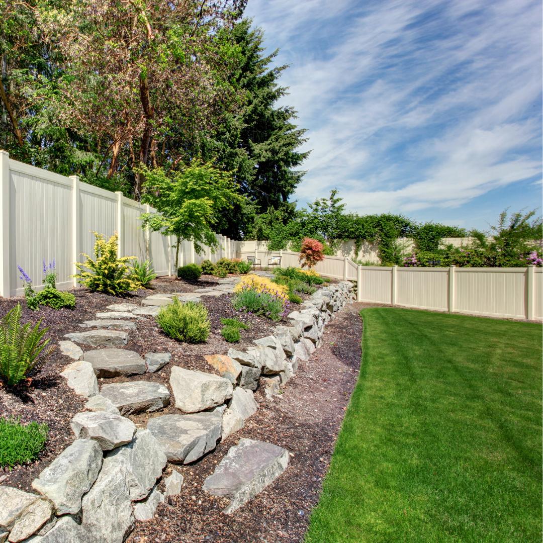 A pretty yard with a white fence.